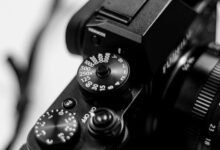 Black and white close-up of a DSLR camera dial highlighting shutter speed settings.