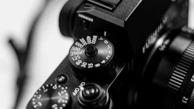 Black and white close-up of a DSLR camera dial highlighting shutter speed settings.