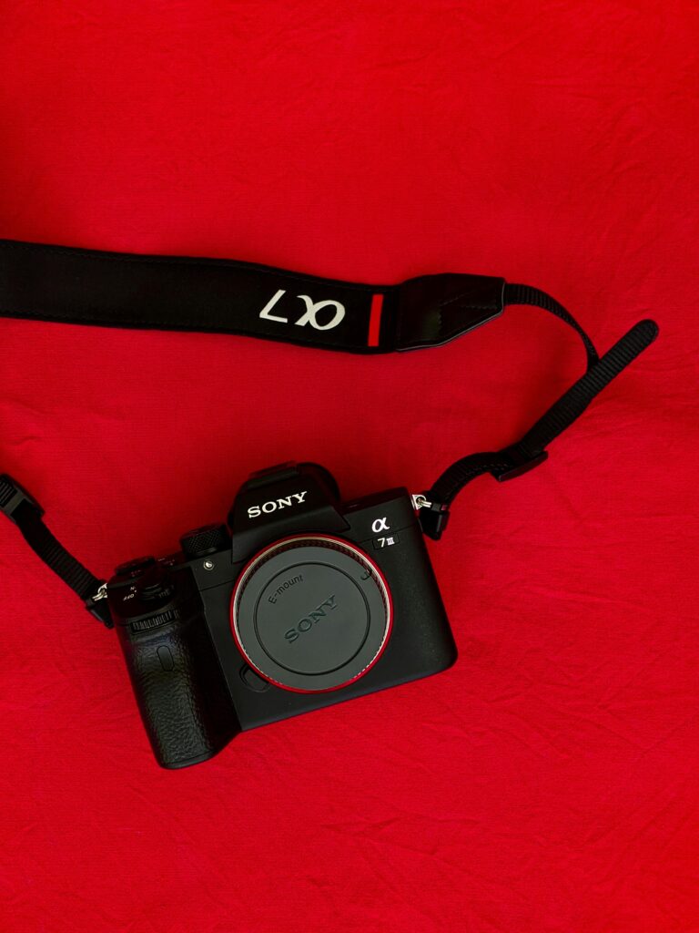 Sony Alpha camera displayed on a vibrant red fabric. Ideal for tech and photography themes.