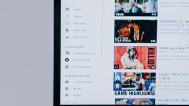 Person browsing YouTube videos on a laptop, showcasing modern technology and online content.