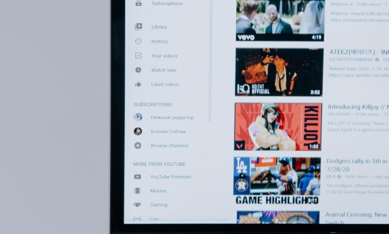 Person browsing YouTube videos on a laptop, showcasing modern technology and online content.